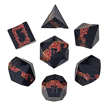 Set of black polyhedral dice with red glittering edges on a white background