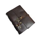 Brown leather journal with a key and wrap on a white background