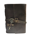Brown leather journal with key wrap on a white background