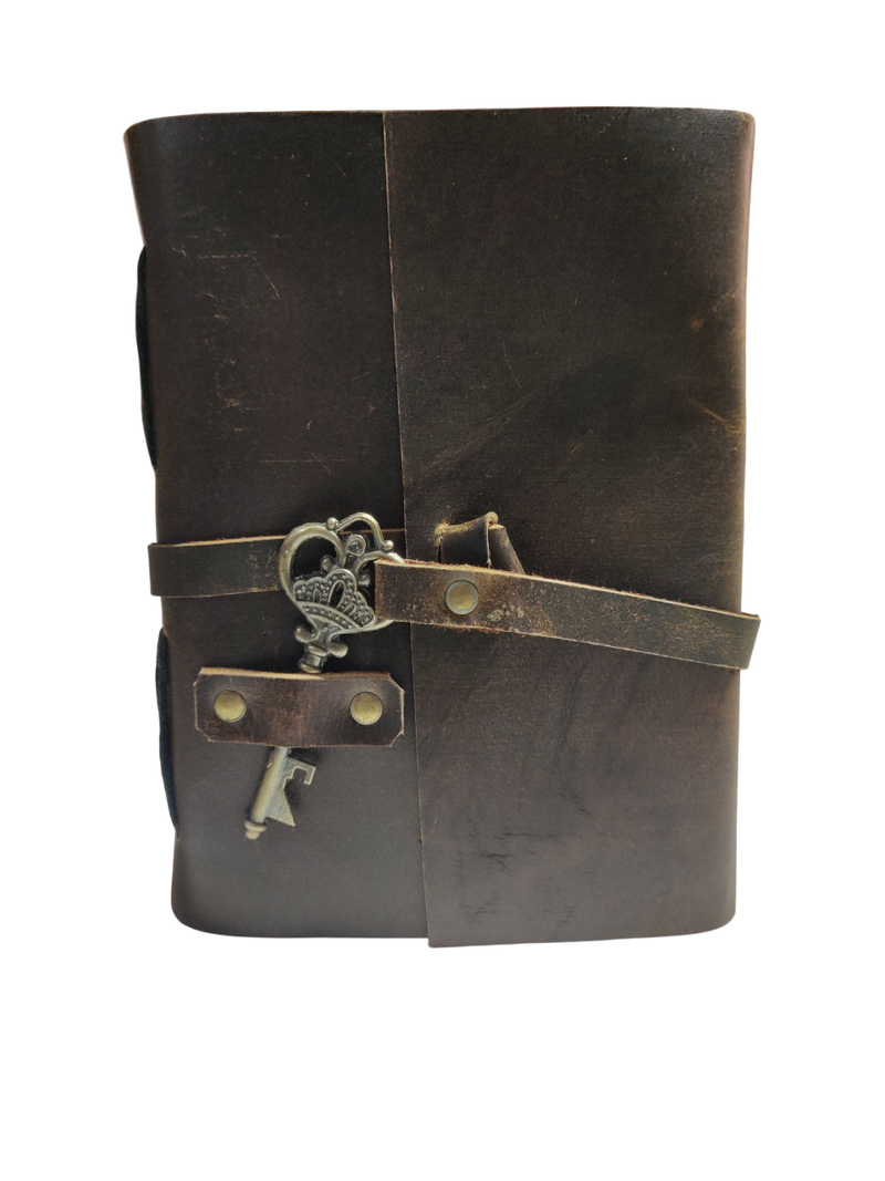 Brown leather journal with key wrap on a white background