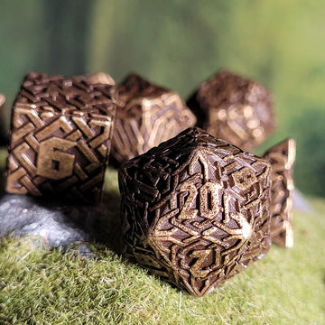 Decorative stone cubes with intricate patterns on a grassy surface