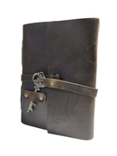 Brown leather notebook with a strap and key on a white background